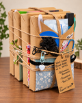 Four individually wrapped surprise romance books bundled with bookish goodies