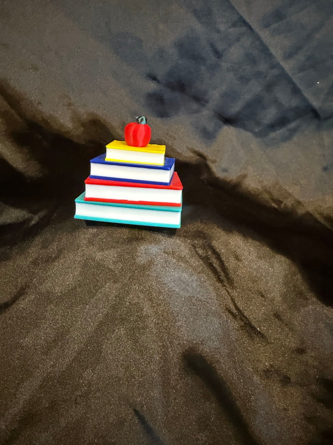 Stacked Book Clicker with Apple side view