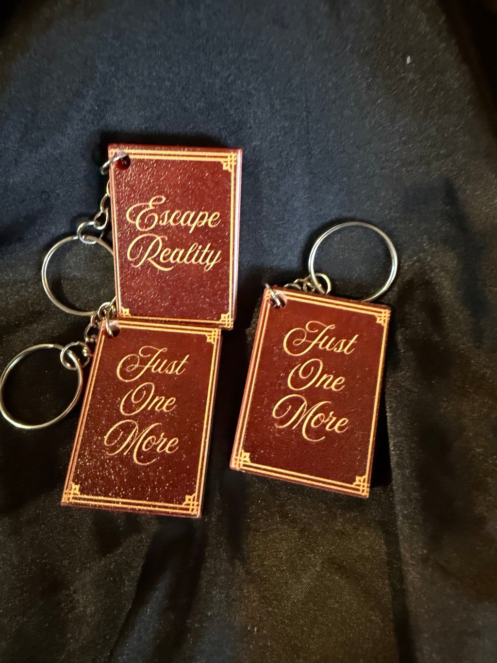 3D printed book can opener keychains, assorted bookish sayings