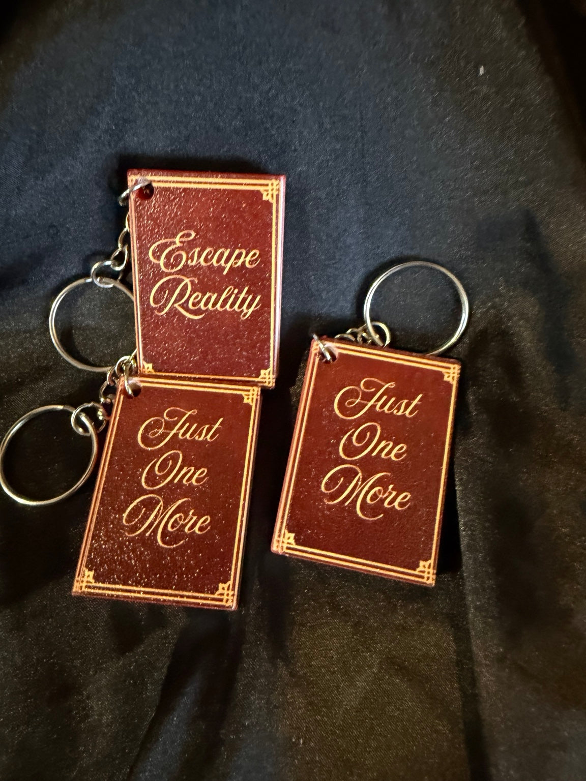 3D printed book can opener keychains, assorted bookish sayings