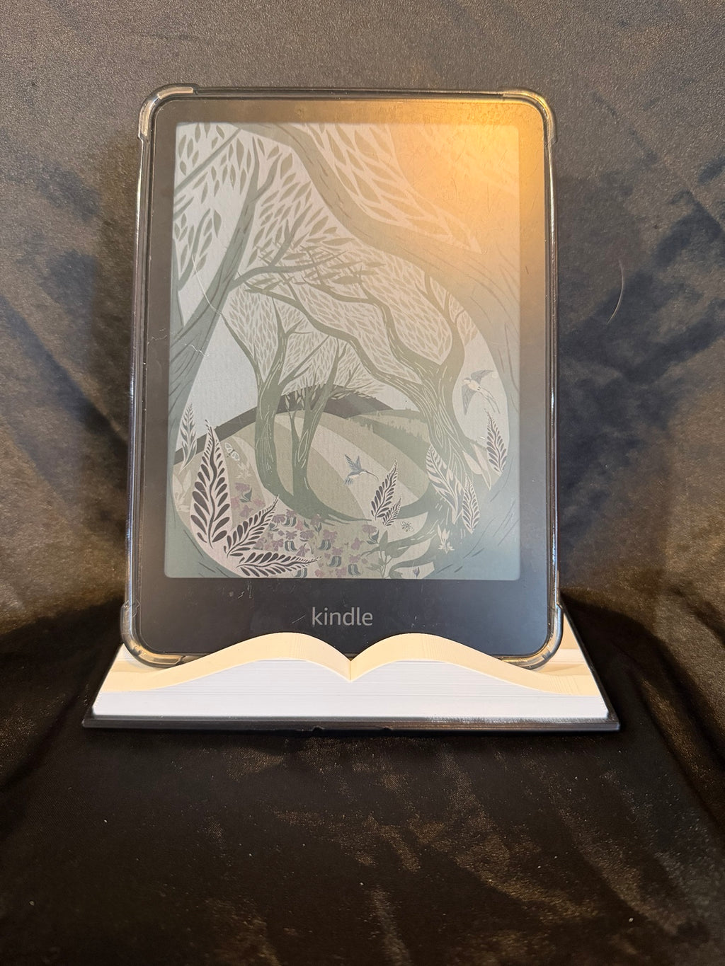 3D printed book-shaped Kindle holder in use
