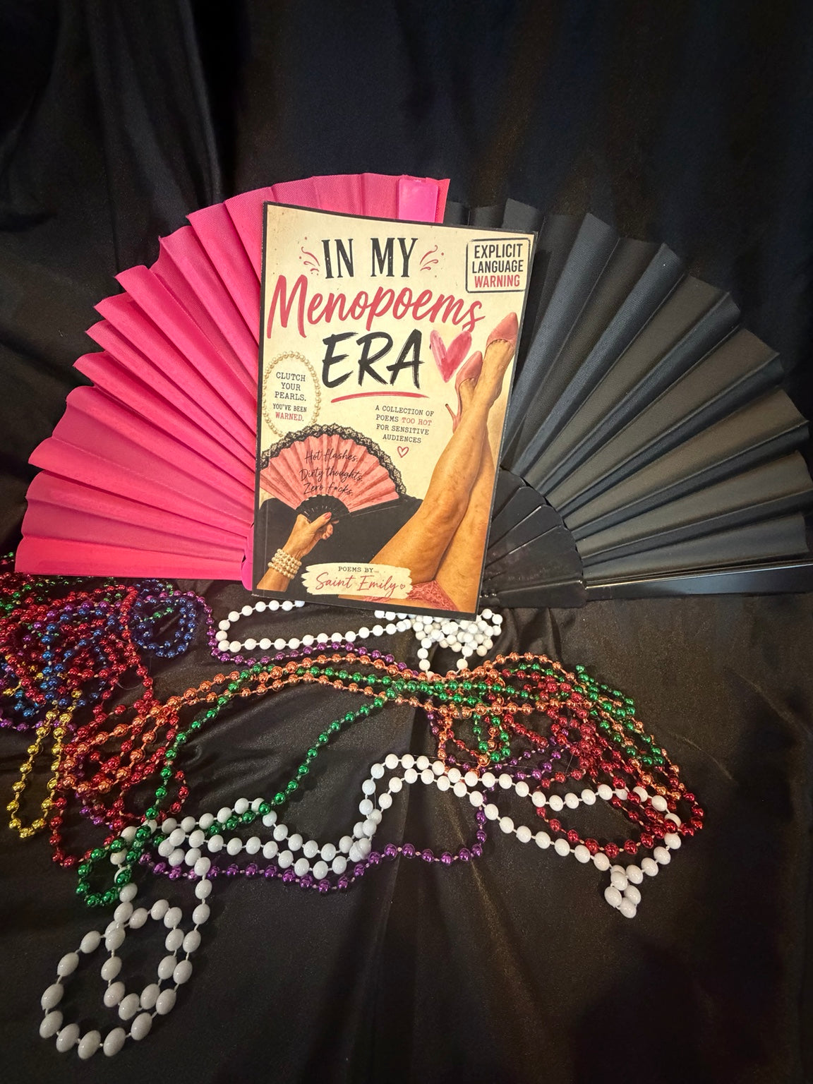 In My Menopoems Era by Emily St. James with promotional fan and pearl accessories